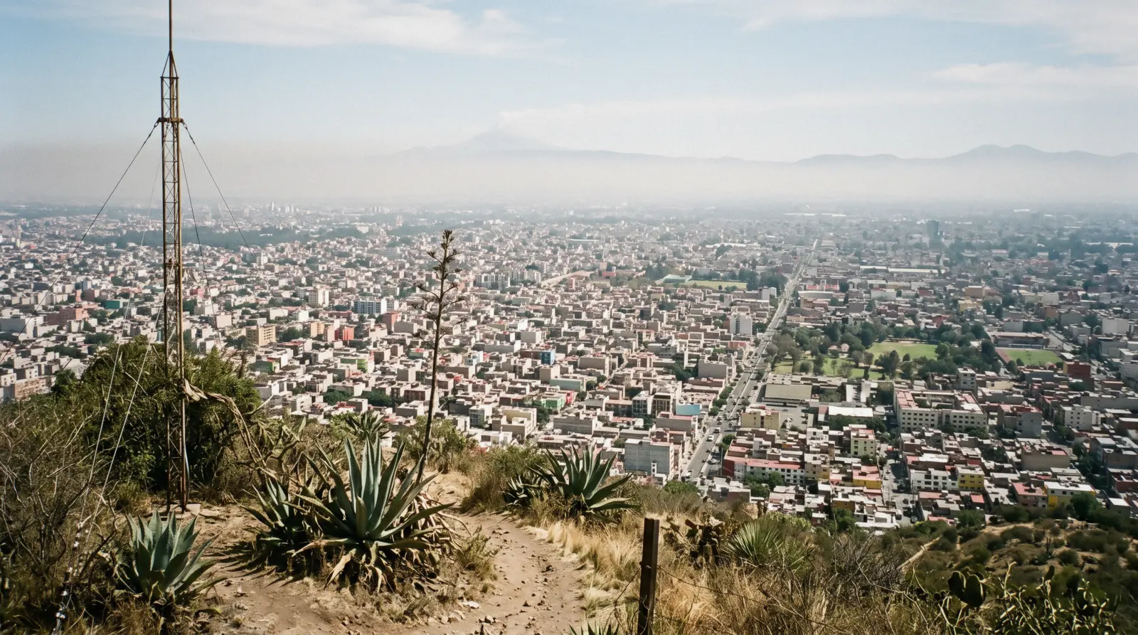 The city spreading across the high valley floor with mountains on the horizon, the altitude of Mexico City