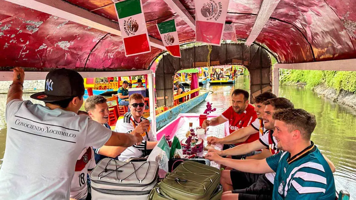 Painted trajinera boats crossing on the canals of Xochimilco, traditional boat tour in Mexico City
